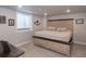 Finished basement bedroom with a rustic wood frame bed and carpet flooring at 16102 Grebe Pl, Parker, CO 80134