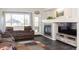 Cozy living room features a fireplace, comfortable seating, and plenty of natural light creating a warm and inviting atmosphere at 16102 Grebe Pl, Parker, CO 80134