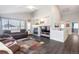 Spacious living room with a fireplace, hardwood floors, and ample natural light, ideal for entertaining and relaxation at 16102 Grebe Pl, Parker, CO 80134