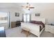 Comfortable bedroom featuring neutral walls, a ceiling fan, and a bench at the end of the white sleigh bed at 16102 Grebe Pl, Parker, CO 80134