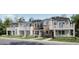 Charming townhomes with stone accents, white trim, and private balconies offer stylish curb appeal at 8959 Whiteclover St, Littleton, CO 80125