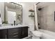 Chic bathroom featuring a dark vanity, modern fixtures, and a shower-tub combination at 9400 E Iliff Ave # 103, Denver, CO 80231