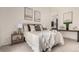 Bright bedroom featuring a comfortable bed, stylish decor, and an ensuite bathroom at 9400 E Iliff Ave # 103, Denver, CO 80231