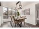 Elegant dining room with a modern light fixture and large windows overlooking the outdoors at 9400 E Iliff Ave # 103, Denver, CO 80231