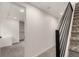 Hallway with carpeted stairs and modern black railing leading to additional rooms at 9400 E Iliff Ave # 103, Denver, CO 80231