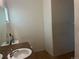 A bathroom features a single sink vanity with a brown countertop, tiled floors, and neutral-colored walls at 14400 Albrook Dr # 88, Denver, CO 80239