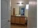 The bathroom features a single sink vanity with a wood cabinet, tiled floors, and neutral-colored walls at 14400 Albrook Dr # 88, Denver, CO 80239