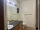 This is a basic bathroom with a single sink vanity, toilet, mirror, and lighting fixture at 14400 Albrook Dr # 88, Denver, CO 80239