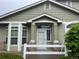 Inviting home exterior featuring a light green color, brick accents and bright white trim at 14400 Albrook Dr # 88, Denver, CO 80239