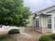 Landscaped front yard with green bushes and a stone pathway leading to the house at 14400 Albrook Dr # 88, Denver, CO 80239