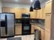 Functional kitchen featuring wooden cabinets, granite counters, and stainless steel appliances at 14400 Albrook Dr # 88, Denver, CO 80239