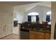 This kitchen has stainless steel appliances, granite countertops, and a view into a living room area at 14400 Albrook Dr # 88, Denver, CO 80239