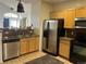 Spacious kitchen area featuring light cabinets and modern stainless steel appliances at 14400 Albrook Dr # 88, Denver, CO 80239