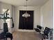 A living room area with exercise equipment, a chandelier, and natural light from the window at 14400 Albrook Dr # 88, Denver, CO 80239