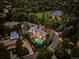 A grand estate featuring a pool, hot tub, lush landscaping, and exquisite outdoor lighting at 27 Polo Club Cir, Denver, CO 80209