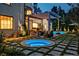 Relaxing backyard with in-ground hot tub, built-in grill, and paver patio at 27 Polo Club Cir, Denver, CO 80209