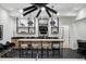 Finished basement with wet bar, stools, unique lighting, and an open floor plan at 27 Polo Club Cir, Denver, CO 80209