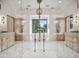 Bright bathroom with herringbone tile, free-standing tub, brass fixtures, glass enclosed shower, and dual sink vanities at 27 Polo Club Cir, Denver, CO 80209