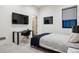 Stylish bedroom featuring a sleek desk, modern decor, and comfortable bed with a TV at 27 Polo Club Cir, Denver, CO 80209