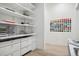 Organized walk-in closet with built-in shelving and drawers, perfect for storage and display at 27 Polo Club Cir, Denver, CO 80209