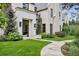 Charming home entrance with stone walkway, manicured lawn, and elegant black framed door at 27 Polo Club Cir, Denver, CO 80209