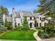 Beautiful home with lush landscaping, a curved walkway, and charming curb appeal at 27 Polo Club Cir, Denver, CO 80209