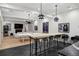 Finished basement with a table, wet bar, decorative lights, and multiple seating areas at 27 Polo Club Cir, Denver, CO 80209