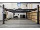 Spacious garage equipped with a car lift, offering ample space for vehicle storage and maintenance at 27 Polo Club Cir, Denver, CO 80209