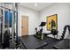 Home gym featuring exercise equipment, wall art, and a full-length mirror at 27 Polo Club Cir, Denver, CO 80209