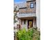 Exterior of charming house with wood siding, gray tile roof, and landscaped front yard at 27 Polo Club Cir, Denver, CO 80209