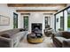 Cozy living room with a modern fireplace, plush seating, and views of the outdoors at 27 Polo Club Cir, Denver, CO 80209