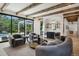 Open living area with a wet bar, cozy seating, and seamless access to an outdoor patio and pool at 27 Polo Club Cir, Denver, CO 80209