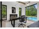 Modern office with a fireplace, large windows offering pool views, and sleek, minimalist design at 27 Polo Club Cir, Denver, CO 80209