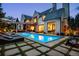 A luxurious backyard with a sparkling pool and comfortable lounge seating under the pergola at 27 Polo Club Cir, Denver, CO 80209