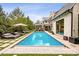 Spacious backyard with a refreshing pool, comfortable lounge area, and manicured landscaping at 27 Polo Club Cir, Denver, CO 80209