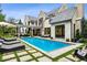 Stunning backyard featuring a sparkling pool, lounge chairs, and a charming pergola area at 27 Polo Club Cir, Denver, CO 80209