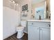 Clean bathroom with shower/tub combo, vanity, and grey cabinets at 5313 S Malaya Way, Centennial, CO 80015