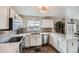 Modern kitchen with white cabinets, quartz countertops, and stainless steel appliances at 5313 S Malaya Way, Centennial, CO 80015