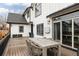 Outdoor deck with table and chairs, and a view of the house's stylish white exterior with black trim at 2020 Teller St, Lakewood, CO 80214