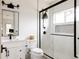 Modern bathroom featuring sleek black fixtures, glass shower, and a stylish vanity with ample storage at 2020 Teller St, Lakewood, CO 80214