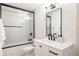 Modern bathroom with white vanity, quartz countertop, a shower with black trim and black bathroom fixtures at 2020 Teller St, Lakewood, CO 80214