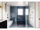 Modern bathroom with a glass-enclosed shower, rain shower head, and a built-in bench at 2020 Teller St, Lakewood, CO 80214