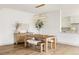 Elegant dining area with a rustic table, stylish lighting, and modern accents at 2020 Teller St, Lakewood, CO 80214