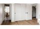 Hallway with hardwood floors, leading to other rooms through white doors and black hardware at 2020 Teller St, Lakewood, CO 80214