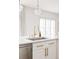 Kitchen island with gold faucet, marble countertop, and custom cabinetry at 2020 Teller St, Lakewood, CO 80214