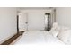 Bright main bedroom with hardwood floors, a plush bed, and white trim at 2020 Teller St, Lakewood, CO 80214