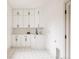 Bright mudroom with white cabinets, modern hardware, and patterned tile flooring at 2020 Teller St, Lakewood, CO 80214