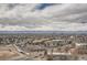 Expansive aerial view showcasing the city and the distant snow-capped mountains under a cloudy sky at 7865 E Mississippi Ave # 1501, Denver, CO 80247