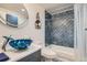 Stylish bathroom featuring a unique blue glass sink and decorative tile shower at 7865 E Mississippi Ave # 1501, Denver, CO 80247