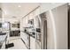 Contemporary kitchen with stainless steel refrigerator, stone countertops and adjacent dining area at 7865 E Mississippi Ave # 1501, Denver, CO 80247